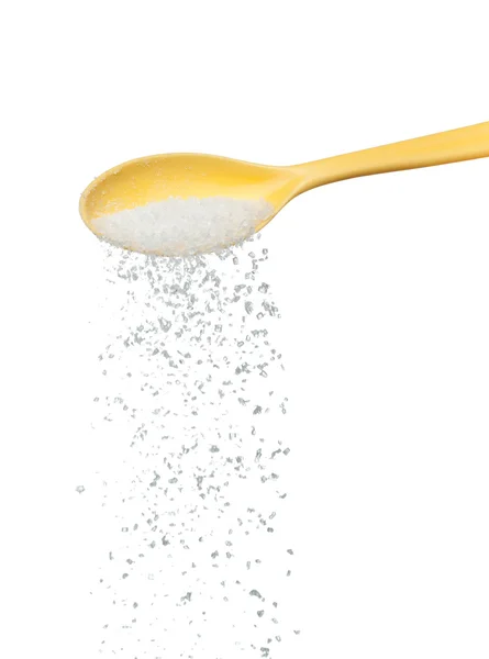 Socker (salt) att hälla från sked — Stockfoto