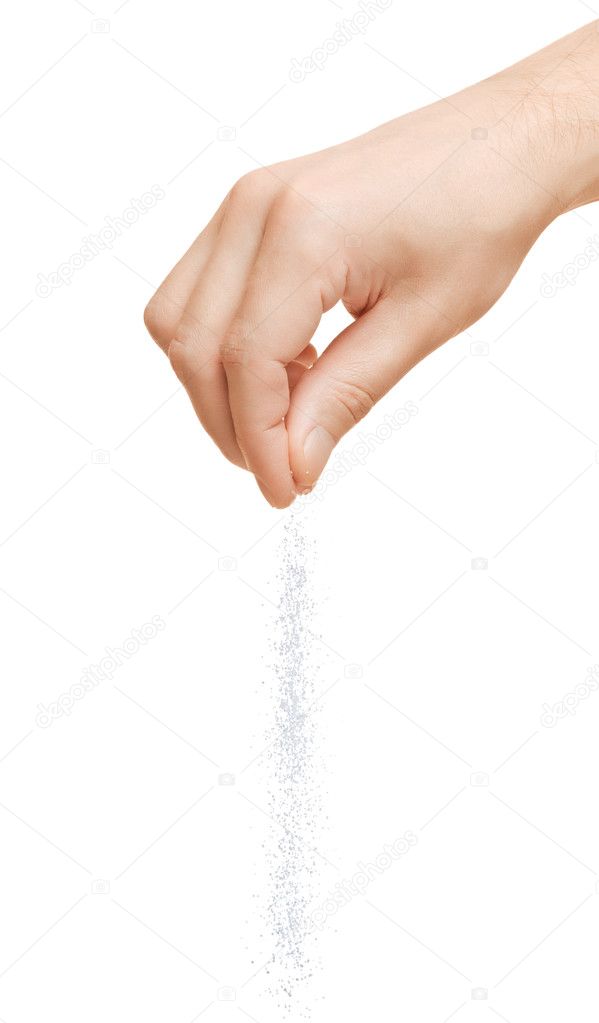 Hand adding salt on a white background