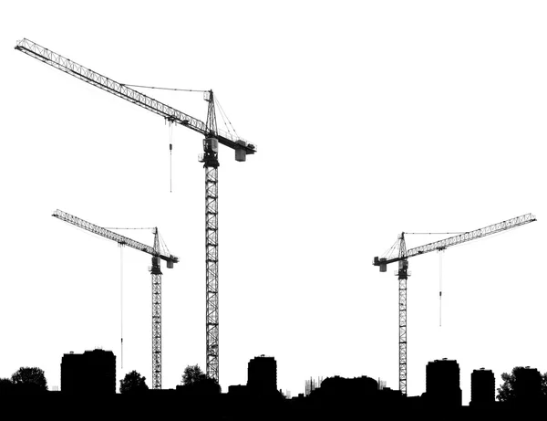 Construcción con grúas y siluetas edificios en un whi —  Fotos de Stock
