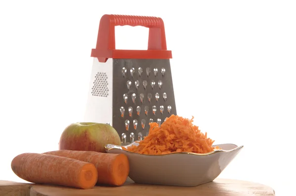 Grated carrots in a cup on a white background — Stock Photo, Image