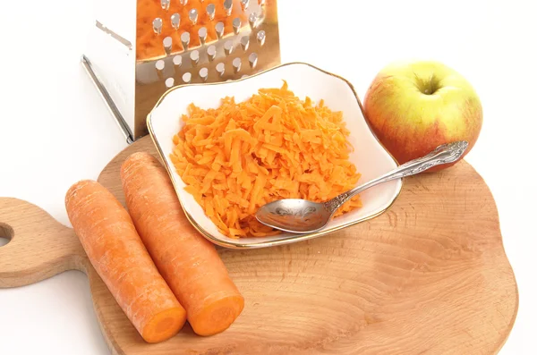 Grated carrots in a cup on a white background — Stock Photo, Image