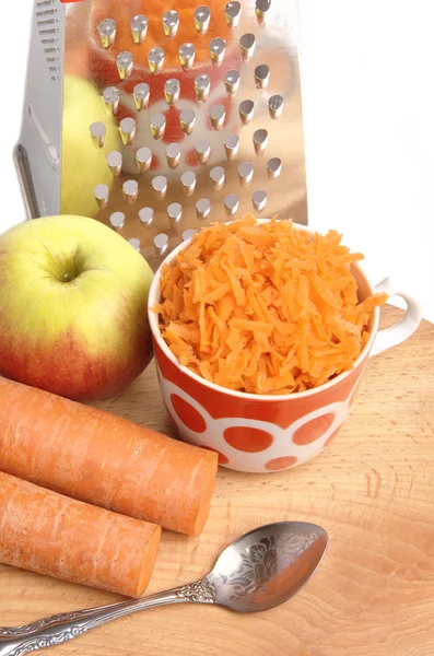 Grated carrots in a cup on a white background — Stock Photo, Image