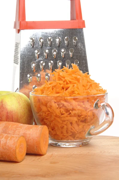 Grated carrots in a cup on a white background — Stock Photo, Image