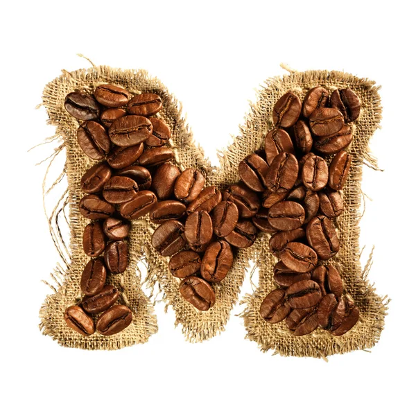 Alfabet z ziaren kawy na na białym tle tekstura tkanina — Zdjęcie stockowe