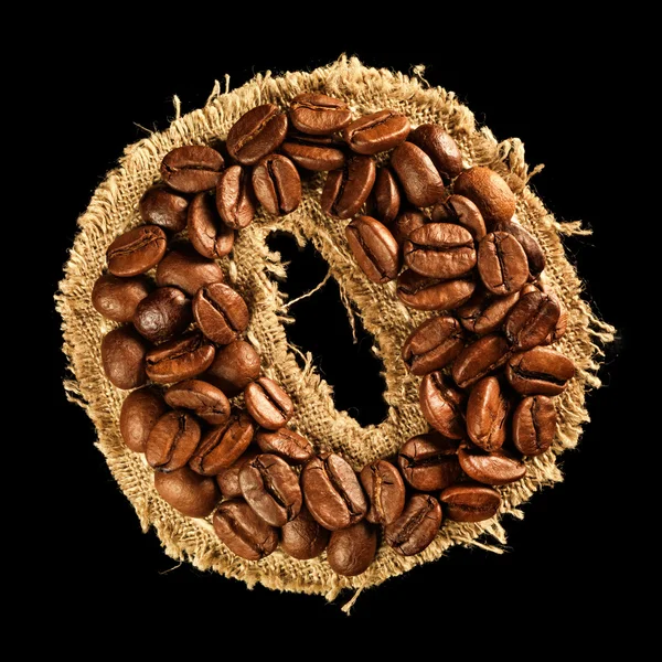 Alphabet from coffee beans on fabric texture isolated on black — Stock Photo, Image