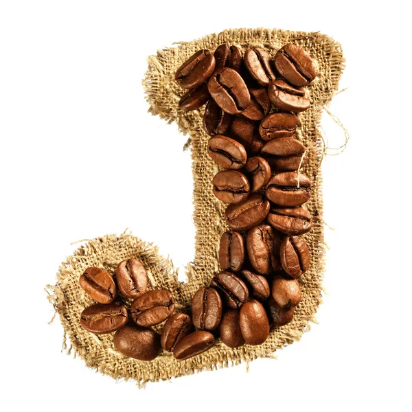 Alphabet from coffee beans on fabric texture isolated on white — Stock Photo, Image