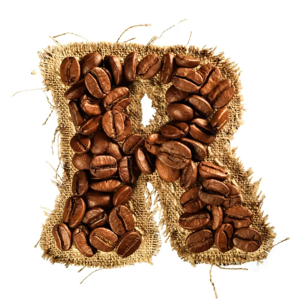 Alphabet from coffee beans on fabric texture isolated on white — Stock Photo, Image