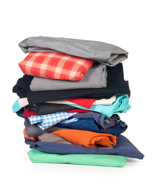 Stapels van kleurrijke kleding op witte achtergrond — Stockfoto