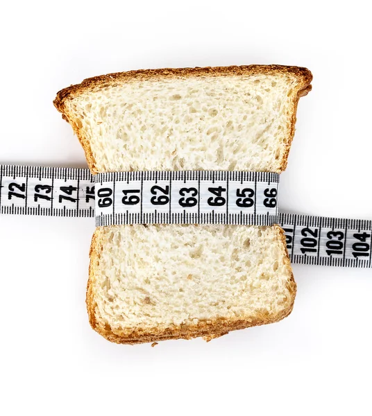 Kus chleba, uchopil měřením páska — Stock fotografie