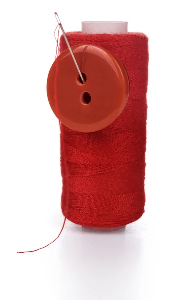 Bobbin thread with needle and button — Stock Photo, Image