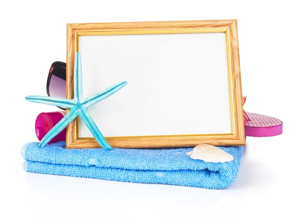 Beach items with towel,flip flops,starfish, sunglasses and a white frame — Stock Photo, Image