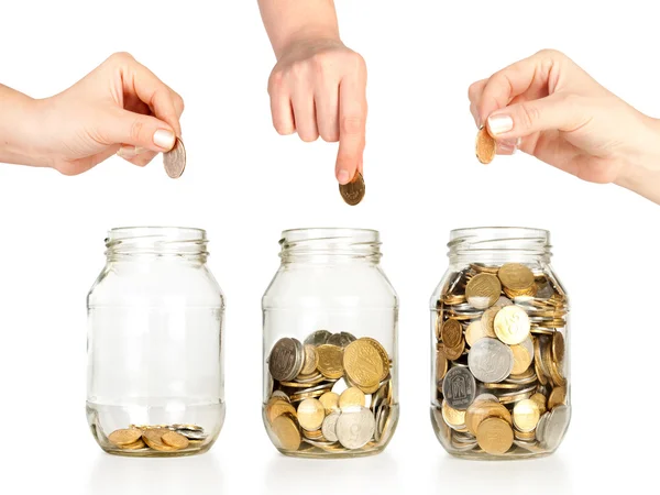 Jars with money and hands — Stock Photo, Image