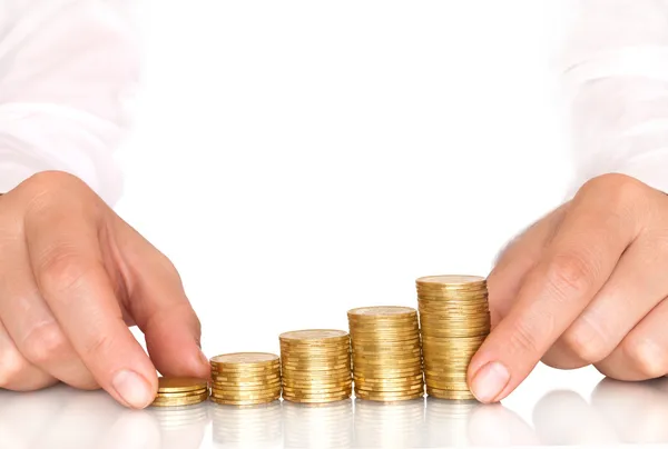 Coins in finger and row stacks — Stock Photo, Image