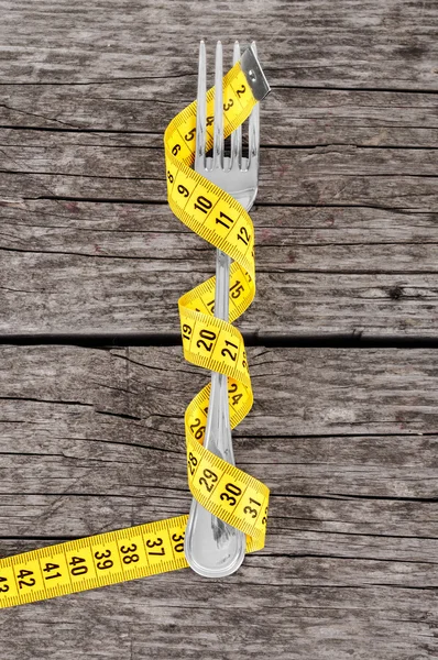 Fork and measuring tape — Stock Photo, Image