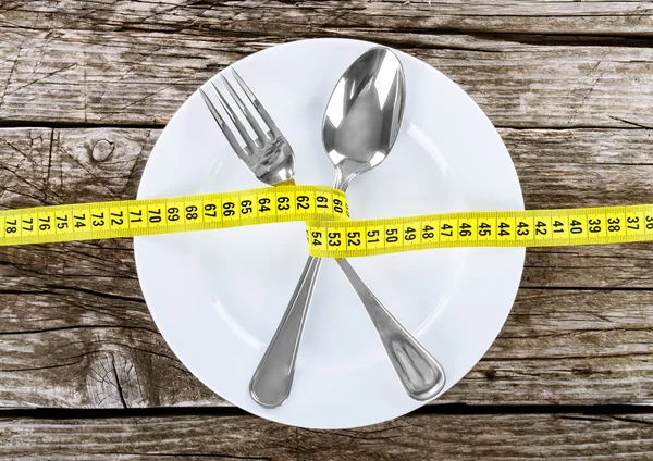Fork and measuring tape — Stock Photo, Image