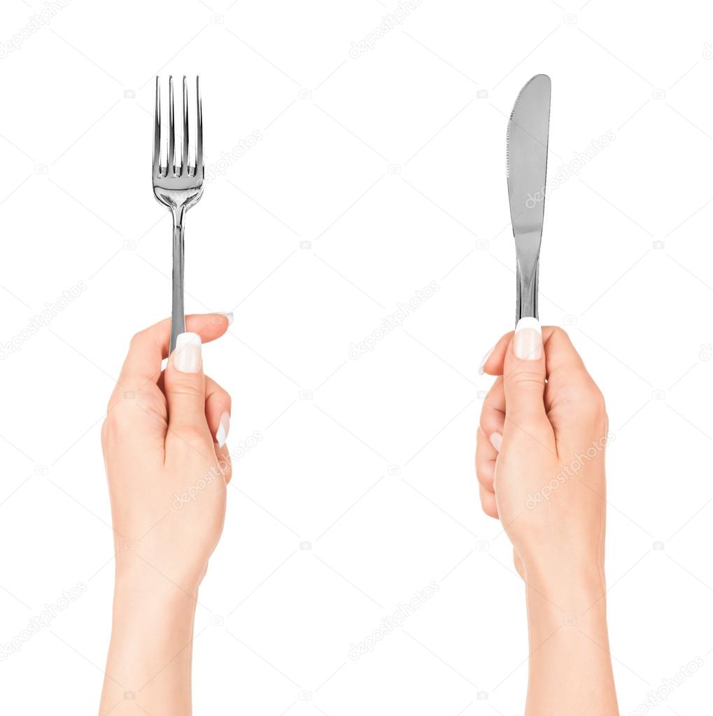 Hand holding fork and knife