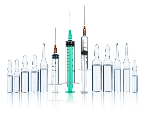 Syringes with needles and medical ampoules on an isolated white — Stock Photo, Image