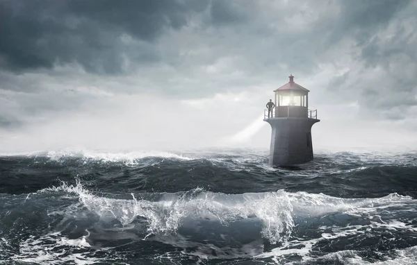 A lonely but strong-minded man standing at a lighthouse in a raging sea