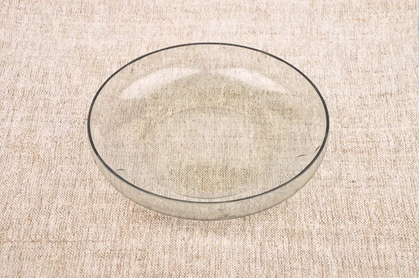Bowl of glass on linen — Stock Photo, Image
