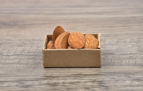 Almonds on wood — Stock Photo, Image