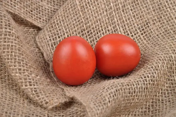 Tomatoes on jute — Stock Photo, Image