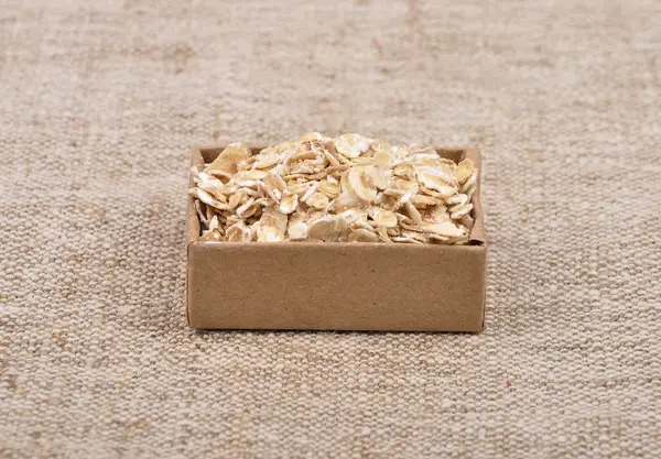 Oat flakes on linen — Stock Photo, Image