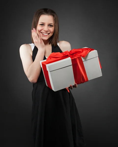 Happy young brunette girl with present — Stock Photo, Image