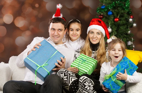 Happy family near the Christmas tree — Stock Photo, Image