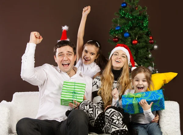 Happy family near the Christmas tree — Stock Photo, Image