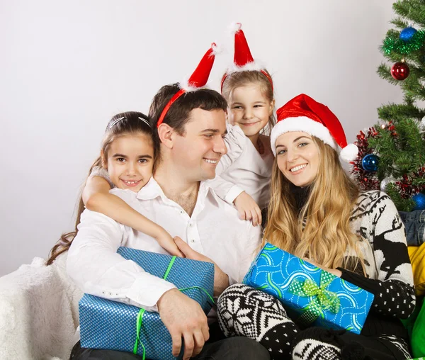 Happy family near the Christmas tree — Stock Photo, Image