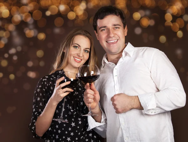 Portrait of a happy young couple on blurred lights background — Stock Photo, Image