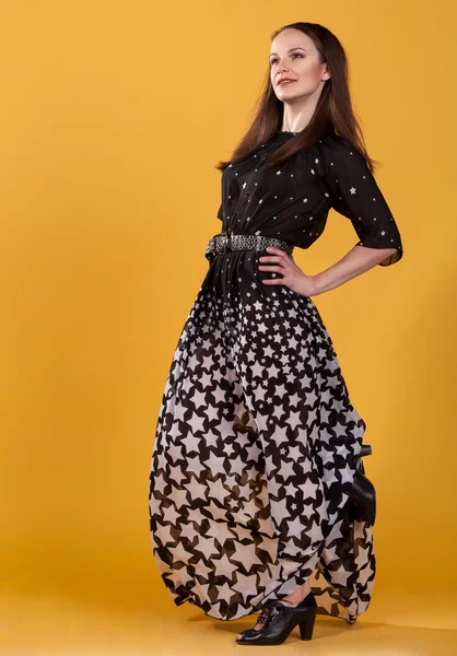 Young attractive brunette woman in long dress — Stock Photo, Image