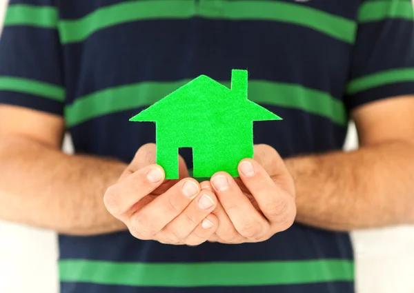 Hands of the man holding green house — Stock Photo, Image