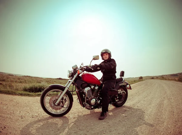 Biker on the road against the sky — Stock Photo, Image