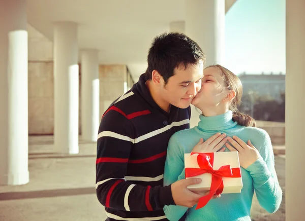 Happy young couple in love with present outdoors — Stok fotoğraf