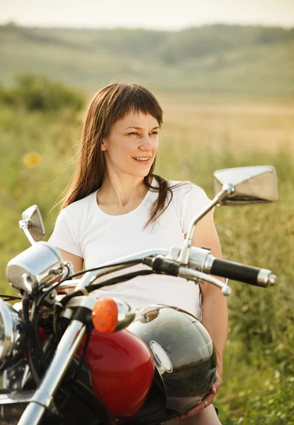 Young biker woman on the country road — Stock Photo, Image