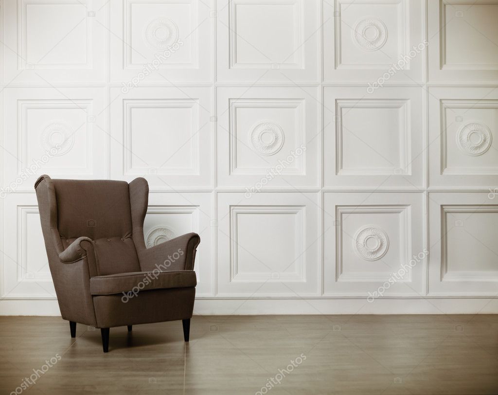 One classic armchair against a white wall and floor