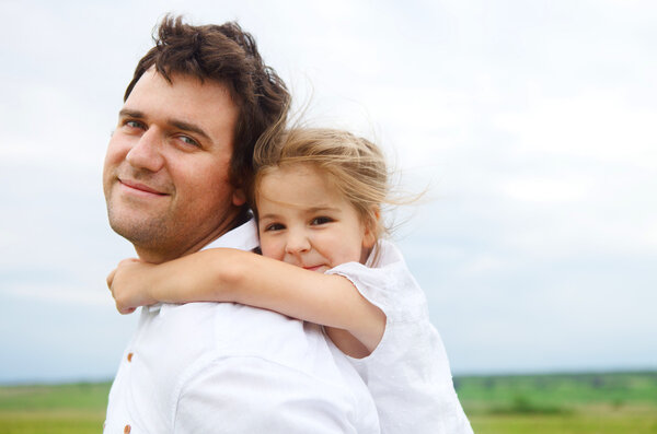 Happy young father with little daughter