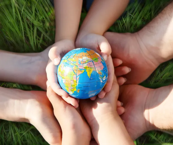 Earth in hands of the family — Stock Photo, Image