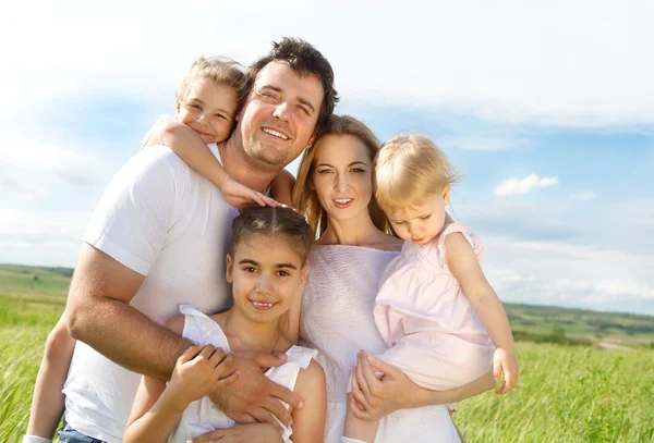 Happy young family with three children — Stock Photo, Image