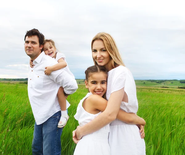 Glad ung familj utomhus — Stockfoto