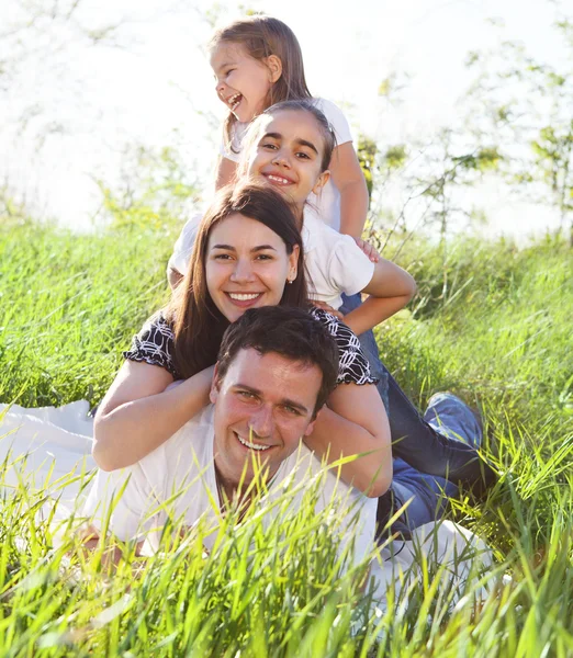 Jovem família feliz com duas crianças — Fotografia de Stock