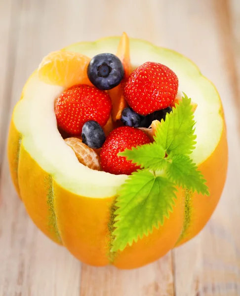 Delicious fresh fruits served in melon — Stock Photo, Image