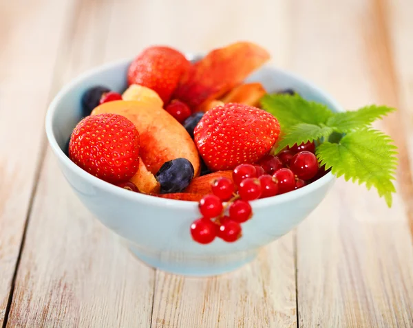 Delicious fresh fruits served in bowl — Stock Photo, Image