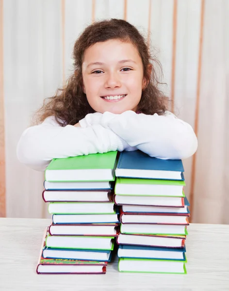 Little girl with pile of books — Stock Photo, Image