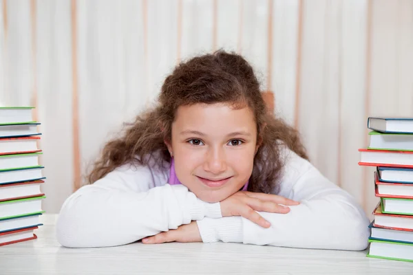 Little girl with pile of books — Stock Photo, Image