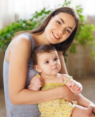 sekiz aylık bebek ile gülümseyen mutlu anne