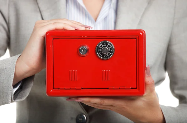 Empresaria sosteniendo caja fuerte roja en sus manos —  Fotos de Stock