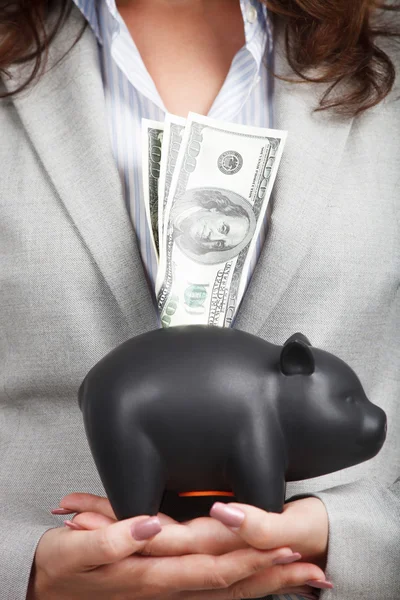 Businesswoman holding the piggy bank and dollar bills — Stock Photo, Image