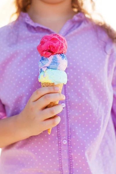 Girl holding ice cream cone in her hands — Stock Photo, Image